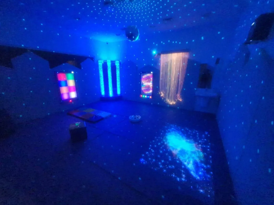 Dark sensory room with fibre optics and bubble tubes